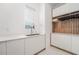 Bright laundry room with a built-in storage and sink at 16106 Pendio Dr, Bella Collina, FL 34756