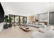 Spacious living room with large windows and modern furniture at 16106 Pendio Dr, Bella Collina, FL 34756