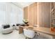 Modern home office with wood wall accents and ample workspace at 16106 Pendio Dr, Bella Collina, FL 34756