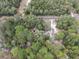 Overview of the property showcasing a private setting surrounded by lush greenery and mature trees at 221 Se 125Th Terrace Rd, Silver Springs, FL 34488