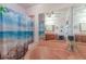 Bathroom with a pink soaking tub, ocean themed shower curtain and large mirrored wall at 221 Se 125Th Terrace Rd, Silver Springs, FL 34488