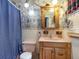 Unique bathroom with whimsical wallpaper, pink fixtures and tile at 221 Se 125Th Terrace Rd, Silver Springs, FL 34488