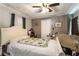 Bedroom with a white bed and a green cactus-themed blanket, plus a ceiling fan and closet at 221 Se 125Th Terrace Rd, Silver Springs, FL 34488