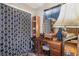 Bedroom closet with patterned privacy curtain, shelves, a vanity and a round mirror at 221 Se 125Th Terrace Rd, Silver Springs, FL 34488
