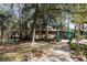 Beautiful home exterior with stone accents, a covered walkway and lush natural surroundings at 221 Se 125Th Terrace Rd, Silver Springs, FL 34488