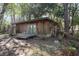 Charming cabin featuring french doors, a wooden porch, and nestled in a private, wooded setting at 221 Se 125Th Terrace Rd, Silver Springs, FL 34488
