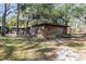 Inviting cabin exterior featuring a nice yard, providing a peaceful and private retreat at 221 Se 125Th Terrace Rd, Silver Springs, FL 34488