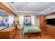 Main bedroom with a bed, mirrored dresser, and a TV, plus a large window with sheer curtains at 221 Se 125Th Terrace Rd, Silver Springs, FL 34488