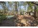 Outbuilding with plenty of storage space, surrounded by tall trees and natural beauty at 221 Se 125Th Terrace Rd, Silver Springs, FL 34488