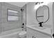 Updated bathroom with a bathtub, modern vanity, and gray tile at 326 Morning Creek Cir, Apopka, FL 32712