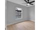 Charming bedroom with window, ceiling fan and light gray walls at 326 Morning Creek Cir, Apopka, FL 32712