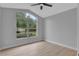 Bright bedroom with large window, ceiling fan, and light gray walls at 326 Morning Creek Cir, Apopka, FL 32712