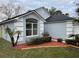 Gray house with a large window and well-manicured landscaping at 326 Morning Creek Cir, Apopka, FL 32712