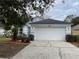 Newly painted house with a two-car garage and landscaped yard at 326 Morning Creek Cir, Apopka, FL 32712