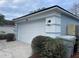 Two-car garage with white door and exterior lights at 326 Morning Creek Cir, Apopka, FL 32712