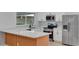 Modern white kitchen with quartz countertops and wooden island at 326 Morning Creek Cir, Apopka, FL 32712