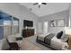 A staged main bedroom with light gray walls, vaulted ceiling, television, and a large window with natural light at 326 Morning Creek Cir, Apopka, FL 32712
