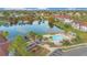 Community pool with surrounding landscaping and a playground at 3714 Palm Desert Ln # 5317, Orlando, FL 32839
