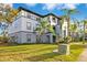 Two-story building with palm trees and a grassy lawn at 3714 Palm Desert Ln # 5317, Orlando, FL 32839