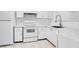 Efficient kitchen with white cabinets and appliances at 3714 Palm Desert Ln # 5317, Orlando, FL 32839