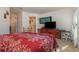 Bedroom with a queen bed, built-in shelving, and a view of the bathroom at 3829 Arborvitae Way, Deland, FL 32724