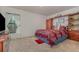 Bedroom with a built-in wooden shelving unit and a queen-size bed at 3829 Arborvitae Way, Deland, FL 32724