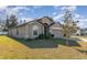 Side view of a gray one-story house with a two-car garage at 3829 Arborvitae Way, Deland, FL 32724