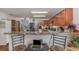 Kitchen with wood cabinets, granite counters and stainless steel appliances at 3829 Arborvitae Way, Deland, FL 32724