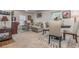 Living room with sectional sofa, dining table, and hardwood floors at 3829 Arborvitae Way, Deland, FL 32724