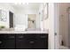 Bathroom with dual sinks, granite countertops, and dark brown cabinets at 4298 Lana Ave, Davenport, FL 33897