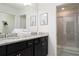 Bathroom with granite countertop, dark brown cabinets and a shower at 4298 Lana Ave, Davenport, FL 33897