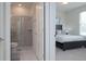 Bedroom with a bed, nightstand, and access to a bathroom at 4298 Lana Ave, Davenport, FL 33897