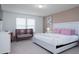 Main bedroom with a king-size bed, crib, and two windows at 4298 Lana Ave, Davenport, FL 33897