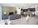 Open concept dining area with gray table and view into living room and kitchen at 4298 Lana Ave, Davenport, FL 33897