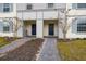 Two townhouses share an entryway with paver walkways and landscaping at 4298 Lana Ave, Davenport, FL 33897