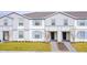 Two-story townhouses with gray siding, blue shutters, and landscaped lawns at 4298 Lana Ave, Davenport, FL 33897