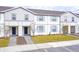 Two-story townhouses with gray siding, blue shutters, and landscaped lawns at 4298 Lana Ave, Davenport, FL 33897