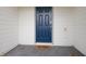 Modern blue front door with a welcome mat at 4298 Lana Ave, Davenport, FL 33897