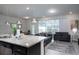 Open concept kitchen with island, stainless steel appliances, and view to Gathering room at 4298 Lana Ave, Davenport, FL 33897