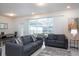 Comfortable living room with gray sofas and sliding glass doors to backyard at 4298 Lana Ave, Davenport, FL 33897