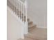 Elegant staircase with white railings and beige carpeting at 4298 Lana Ave, Davenport, FL 33897