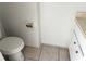 This bathroom features a toilet, tile floor, and a vanity with a marble-look countertop at 5123 Picadilly Circus Ct # 2, Orlando, FL 32839