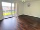 Bright bedroom with wood-look flooring, ceiling fan, and sliding glass doors to a balcony at 5123 Picadilly Circus Ct # 2, Orlando, FL 32839