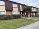 Brick townhouses with brown roofs and landscaping at 5123 Picadilly Circus Ct # 2, Orlando, FL 32839