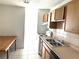 This kitchen features linoleum countertops and tiled backsplash, along with light wooden cabinets at 5123 Picadilly Circus Ct # 2, Orlando, FL 32839