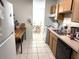 Kitchen with wood cabinets, stainless steel sink, and dining area at 5123 Picadilly Circus Ct # 2, Orlando, FL 32839