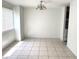 View of the living room, with tile floors, chandelier and a glimpse of the kitchen at 5123 Picadilly Circus Ct # 2, Orlando, FL 32839