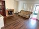 Living room with laminate wood floors and fireplace at 5123 Picadilly Circus Ct # 2, Orlando, FL 32839
