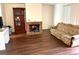 Living room with laminate wood floors and fireplace at 5123 Picadilly Circus Ct # 2, Orlando, FL 32839