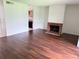 Open living area with wood-look floors, fireplace, and partial kitchen view at 5123 Picadilly Circus Ct # 2, Orlando, FL 32839